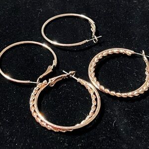 Two pair Rose Gold tone pierced sets of two 1.5 inch hoops. Shimmery earrings
